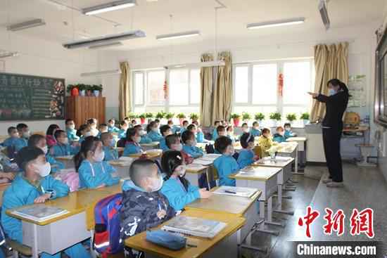 乌鲁木齐市第一小学开学第一天,学生们带着口罩听讲。 陶拴科 摄 新疆中小学和中职学校全面开学复课
